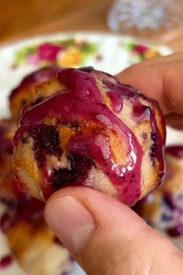 healthy baked blueberry donut hole drizzled with blueberry jam glaze