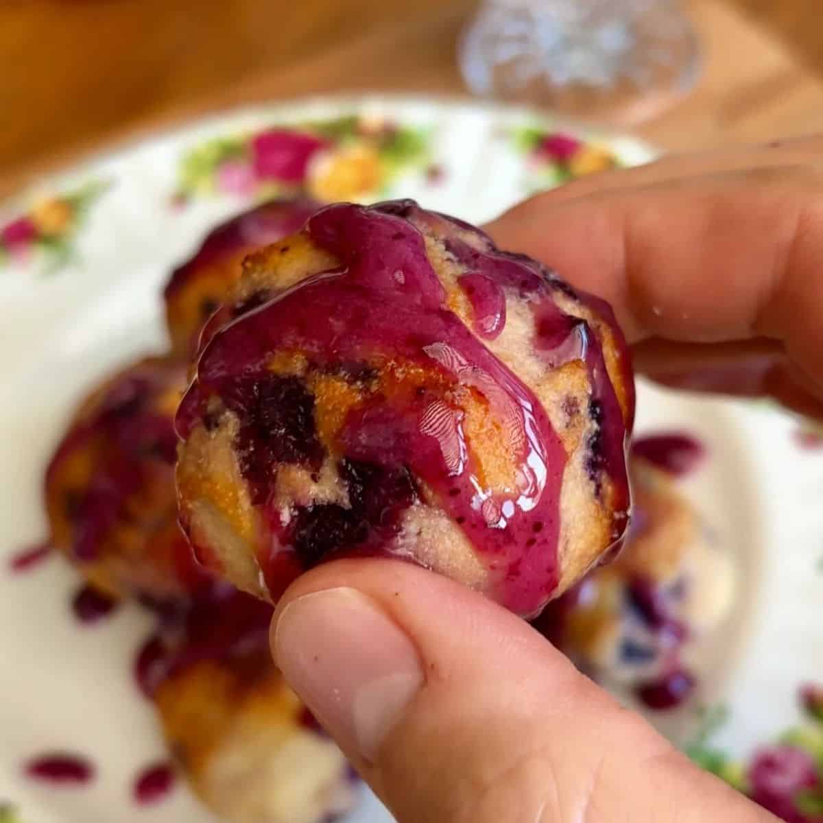 healthy baked blueberry donut hole drizzled with blueberry jam glaze