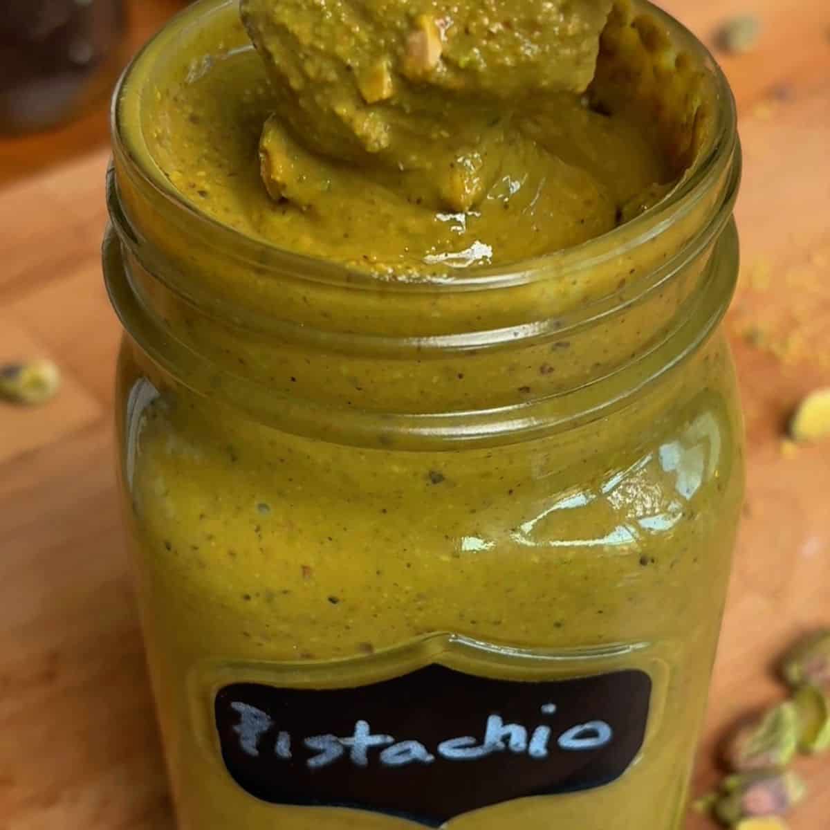 homemade pistachio butter in a mason jar labeled Pistachio