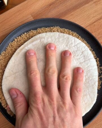 a tortilla and ground chicken being coated in breadcrumbs in prep for the making of a crispy mcchicken smash taco