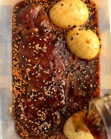 a crispy steak and soft boiled eggs being prepped with miso soy sesame marinade