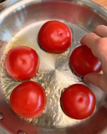 tomato in a frying pan being prepped for one pan creamy tomato pasta