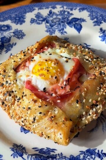 a finished crispy rice paper croque madame on a plate