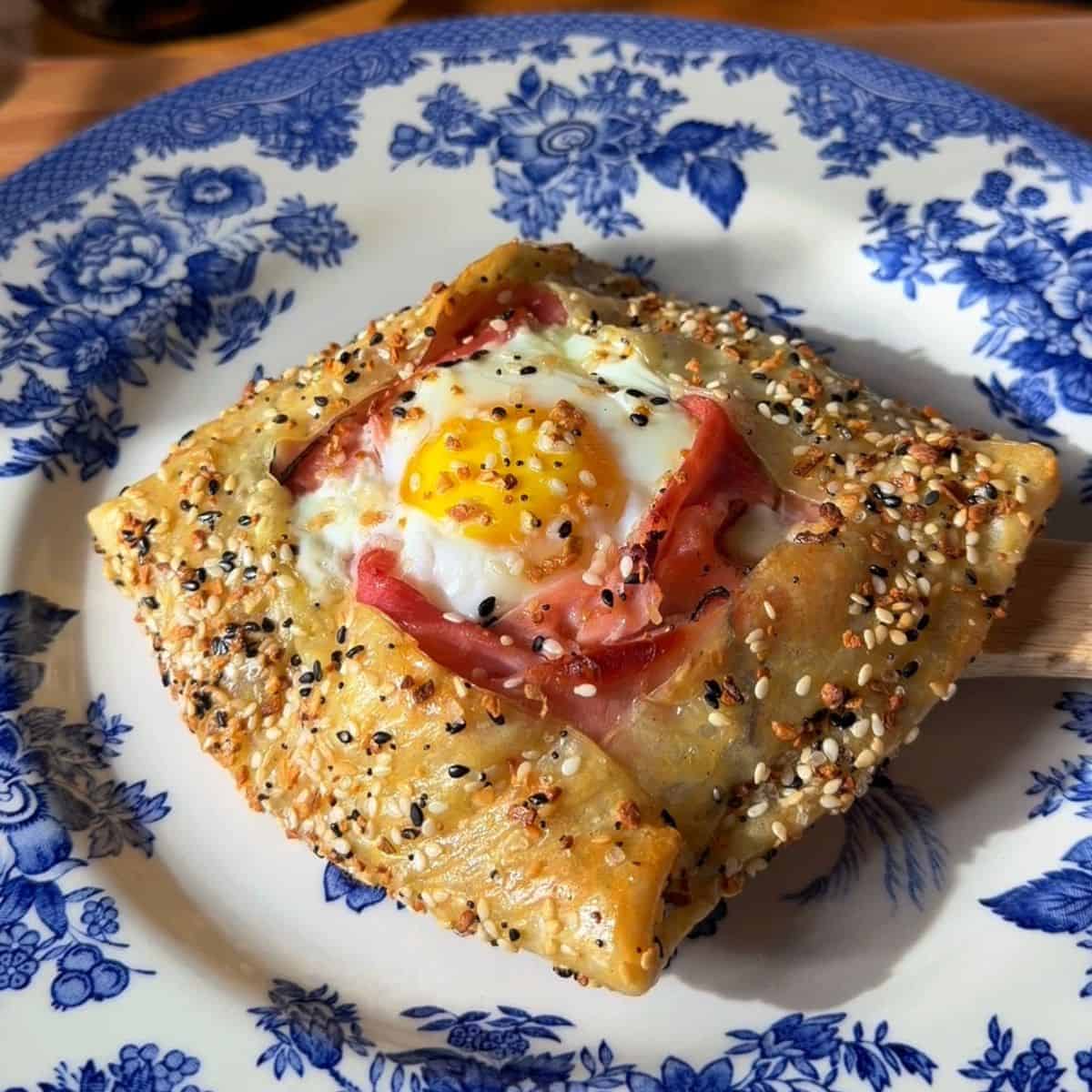 a finished crispy rice paper croque madame on a plate