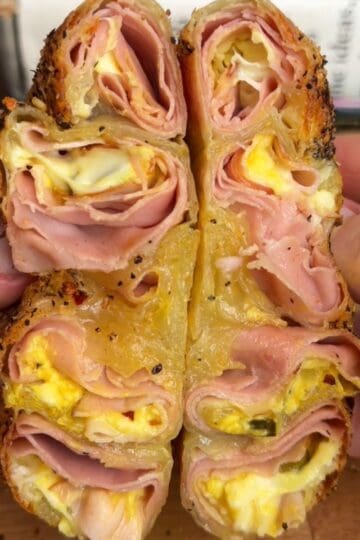 a crispy cuban rice paper sandwich cut in half, with melty cheese and crispy ham in the middle