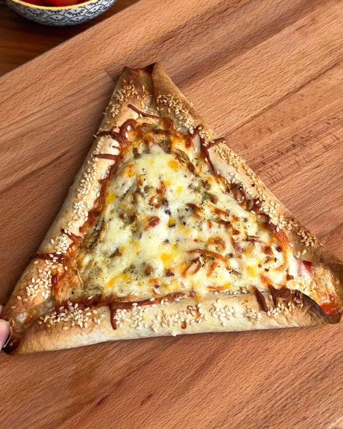 a breakfast pizza with sausage stuffed tortilla crust, with soft egg yolk, marinara and melty cheese