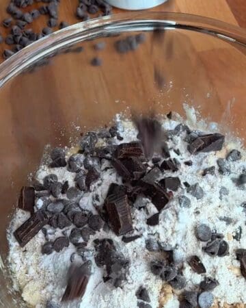 yogurt, banana, egg, maple syrup, almond flour, chocolate chips in a bowl for the making of caramelized banana chocolate chunk blondies