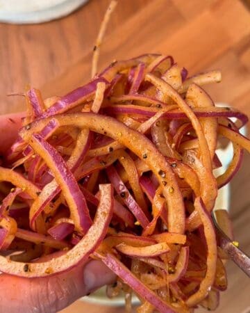 sliced red onions, drenched in oil and spices, pickling for topping