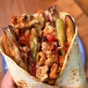 a juicy, flavorful chicken shawarma wrap with a garlicky yogurt sauce and fries