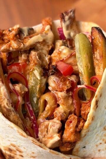 a juicy, flavorful chicken shawarma wrap with a garlicky yogurt sauce and fries