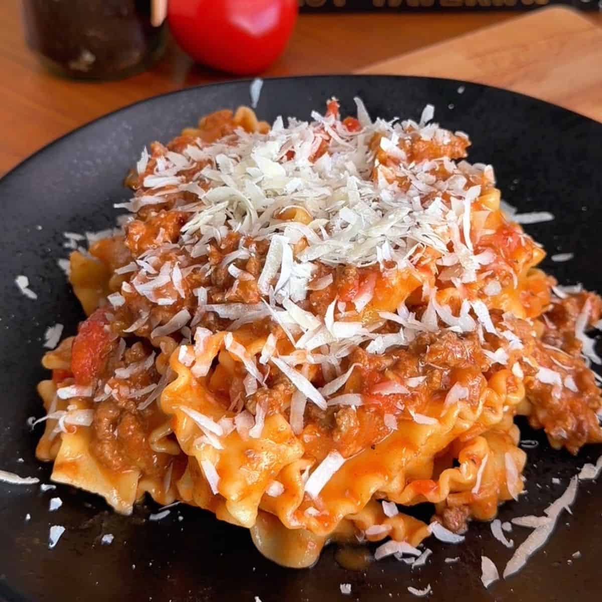 Delicious cheesy beef lasagna with rich tomato sauce and melted cheese on top.