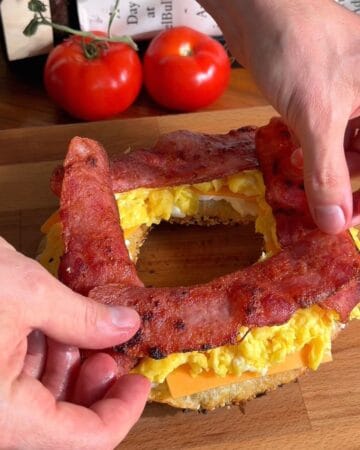 crispy rice paper sandwich being layered with cheese, scrambled egg and turkey bacon