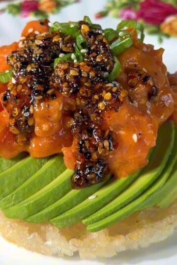 crispy rice waffle, made in a mini waffle maker, topped with avocado, salmon, green onion and chili oil