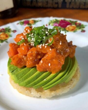 crispy rice waffle, made in a mini waffle maker, topped with avocado, salmon, green onion