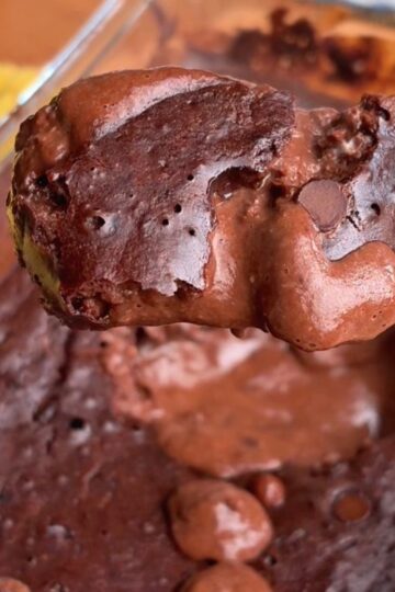 a chocolatey spoonful of high protein molten chocolate lava cake with chocolate chips and a gooey, melty center