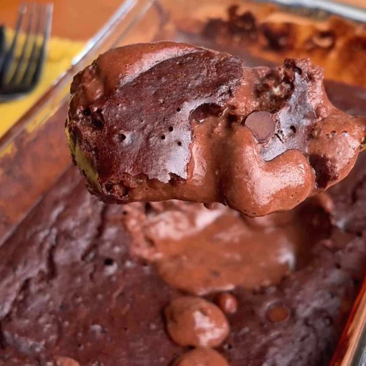a chocolatey spoonful of high protein molten chocolate lava cake with chocolate chips and a gooey, melty center