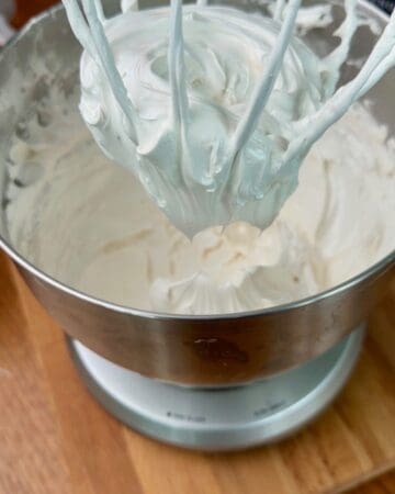 homemade marshmallow fluff being whipped in a mixing bowl