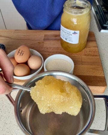 honey being added to a pan for the making of homemade marshmallow fluff
