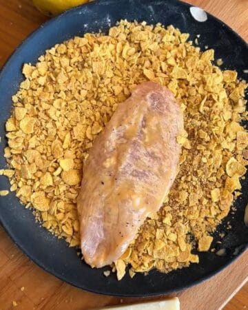 chicken cutlet on top of crispy cornflake panko