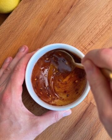 hot honey being mixed in a small bowl for serving