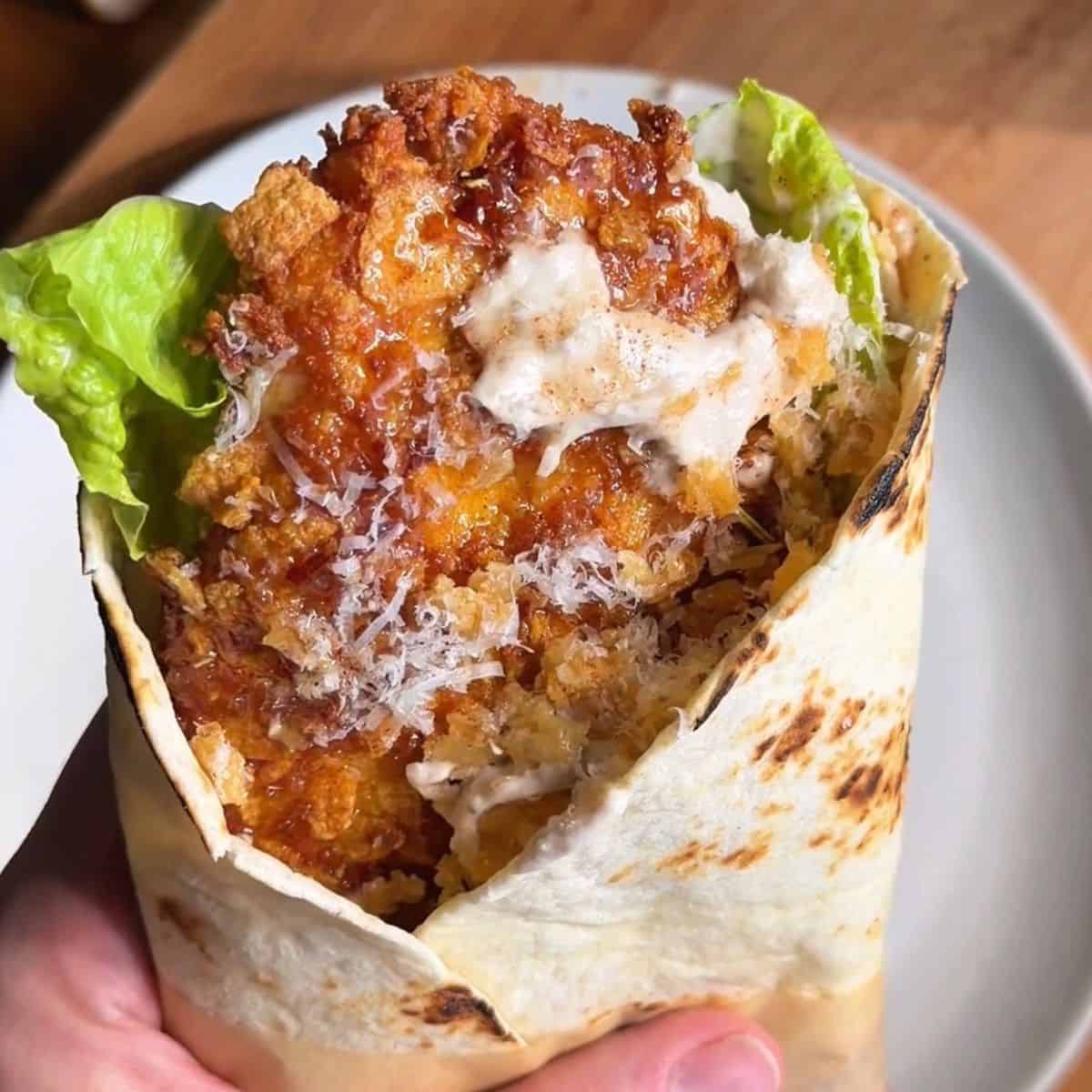finished hot honey cornflake chicken caesar wrap, ready to be eaten