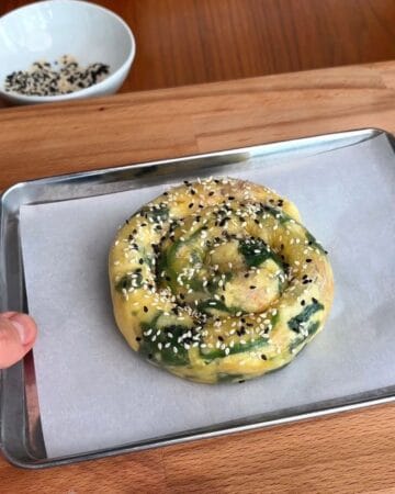 a rice paper spanakopita spiral on a baking sheet before going in the oven