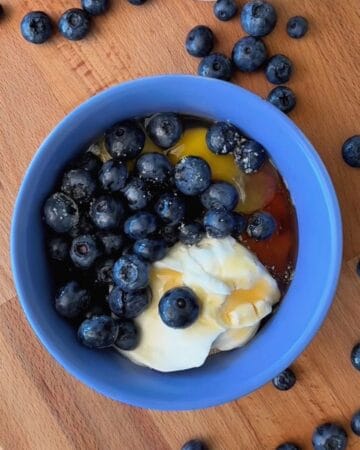 fresh blueberries being gently folded into almond flour waffle batter