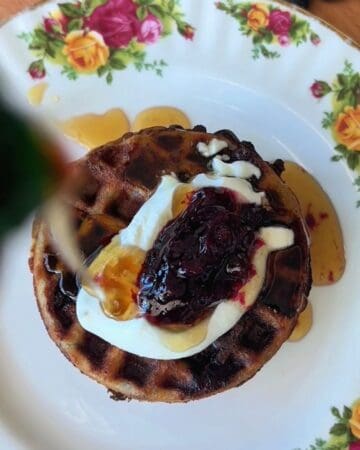 stack of healthy blueberry mini waffles served with yogurt and maple syrup