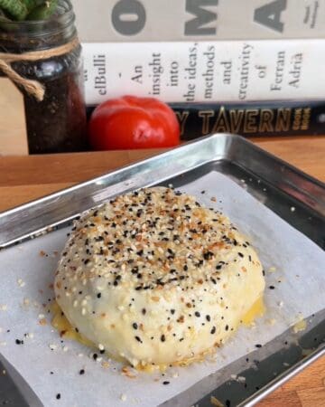 a breakfast sandwich wellington covered in everything bagel seasoning before it goes in the oven