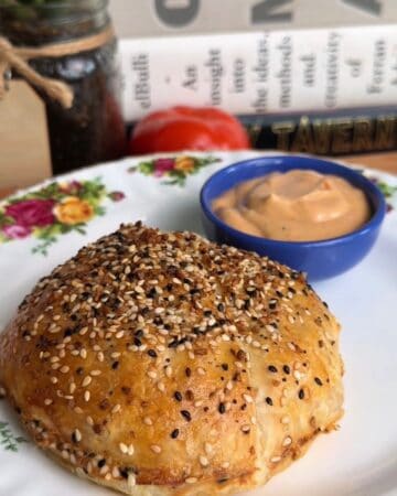 a fully baked, crispy, golden-brown breakfast sandwich wellington on a plate, ready to be eaten