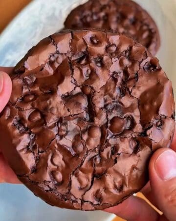 fudgy brownie cookies with crackly tops cooling after baking