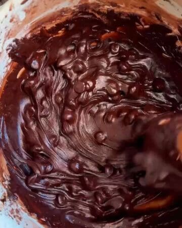 brownie cookie batter ready to be scooped onto parchment lined baking sheet spaced apart
