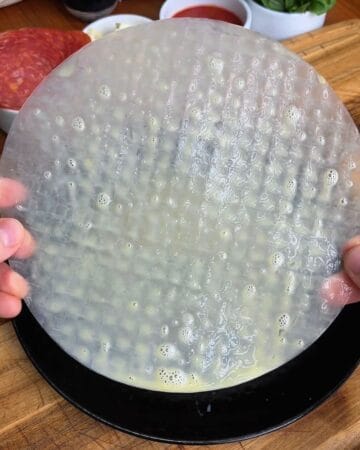 rice paper sheet dipped in egg wash for the making of a pepperoni pizza rice paper spiral