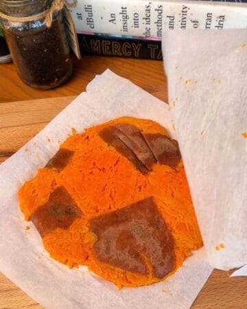a smashed roasted sweet potato, ready to be crisped in a frying pan for the making of a crispy sweet potato pancake