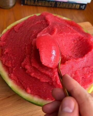 Watermelon sorbet served in a hollowed-out watermelon half, ready to enjoy a refreshing treat.