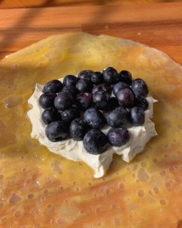Blueberries with whipped ricotta on a rice paper sheet