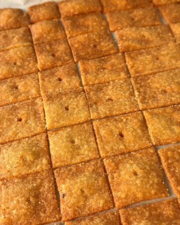 Golden homemade Cheez It squares arranged baked in a grid