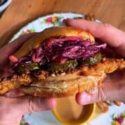 Delicious hot honey chicken sandwich on toasted brioche bun with pickled slaw and dill pickles