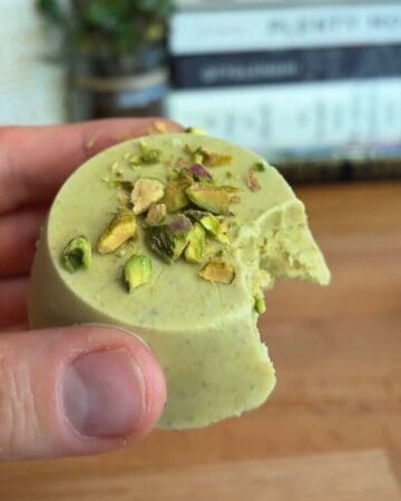 Close-up of pistachio frozen yogurt cup with chopped pistachios on top.