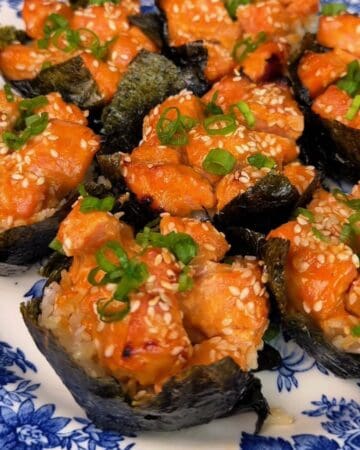 Delicious salmon sushi cups topped with green onions and sesame seeds.