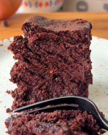 Rich, moist two-bite chocolate brownies being cut with a fork