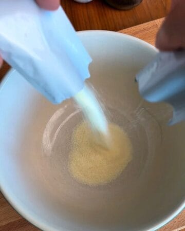 unflavored gelatin sprinkled over cold water in a bowl to bloom for 5 minutes
