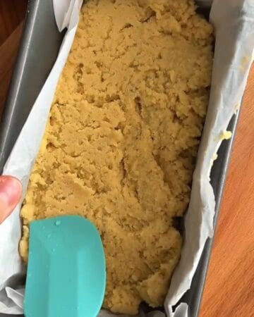 gluten free lemon bar batter in a baking pan with parchment paper.