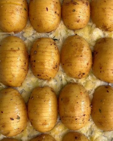 Close-up of fresh baby potatoes with herbs and seasoning.