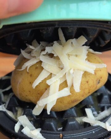 Baked potato topped with shredded cheese and placed in a waffle maker.