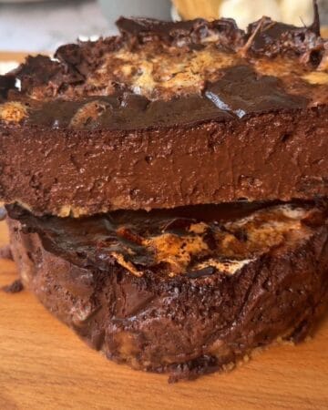 Rich chocolate s'mores cheesecake with gooey center and melted chocolate topping.